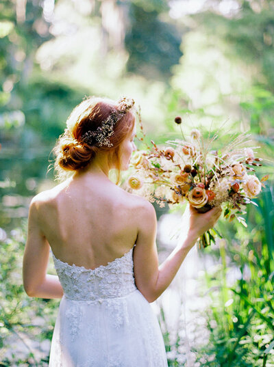 Anais gown from Claire Pettibone with hand-crafted 3-D detailing for a sun-kissed bridal portrait with a golden bouquet