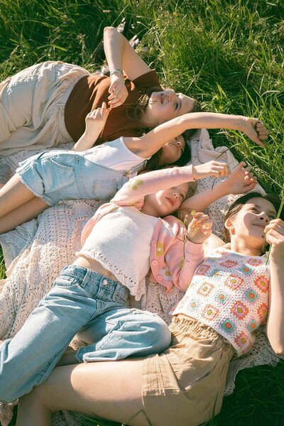 four girls laying in grass in california