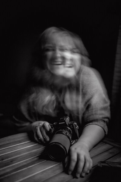 Double exposure image of Rachel laughing with her camera