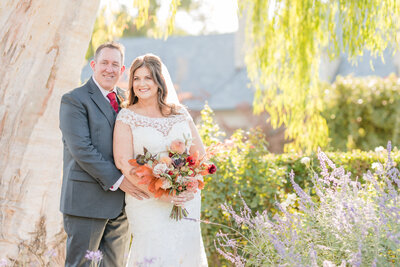 bride and groom portrait with pink bouquet
