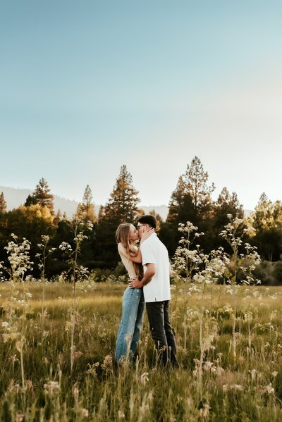 A couple sharing a kiss in the Tahoe Meadows.