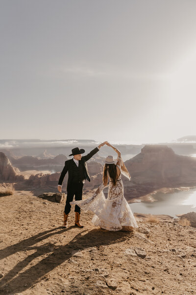 bride and groom dance on cliff
