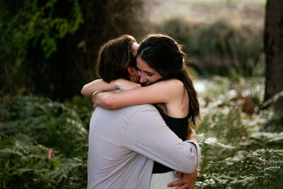 Man holding woman in his arms with horizon in the background