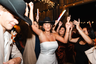 Bride and groom sharing a joyful dance during their indoor wedding reception in Kentucky, surrounded by warm light and celebration.