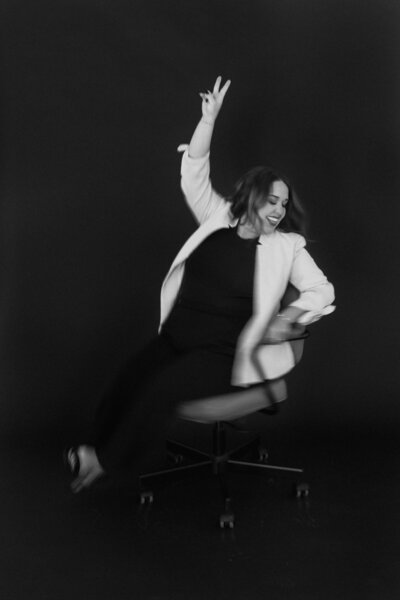 Candid black and white photo of wedding planner celebrating the creative, joyful spirit behind The Eventful Gals brand.