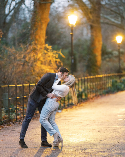 Newly engaged couple kissing under the streetlights in London