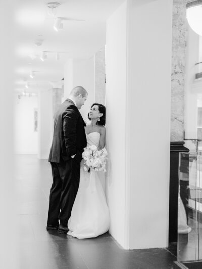 Bride and groom looking at each other in hallway, taken by one of the top baltimore photographers
