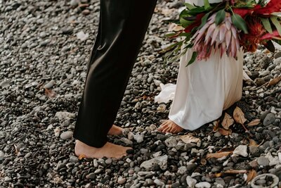 bride and groom barefoot in the sand