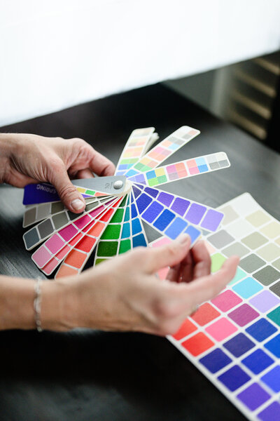A denver product photographer takes a picture of color swatches during a brand photo session for a color analysist.