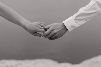 couple sharing a romantic embrace as they reach out hands for one another in washington d.c.