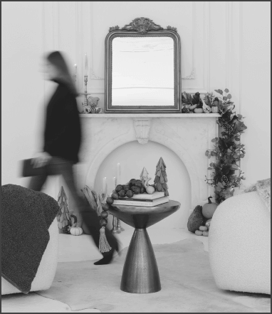 Blurred photo of a woman walking across a room in a furnished photo studio.