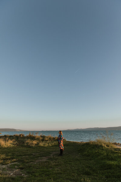 Marta Custic standing in field by the sea