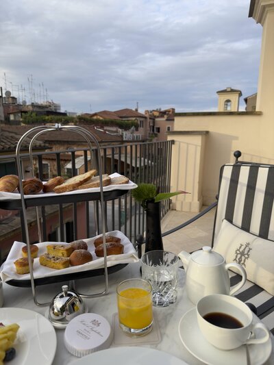 Elegant breakfast spread on a private balcony at Hotel d'Inghilterra in Rome