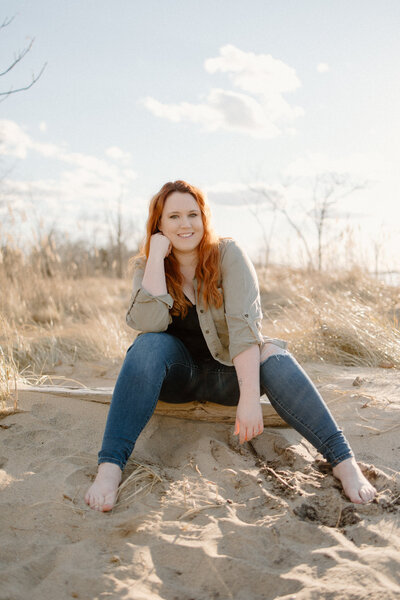 Picture of Bethany Simms sitting on a beach smiling