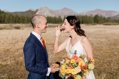 A bride and groom share chocolate cookie in Tuolumne Meadows in Yosemite National Park. 