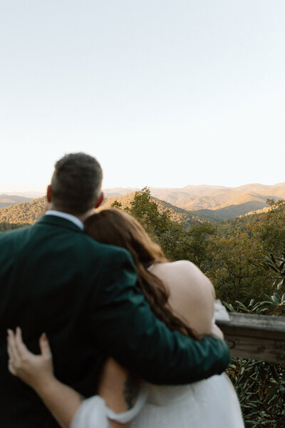 bride and groom embracing each other slowing going in for a kiss