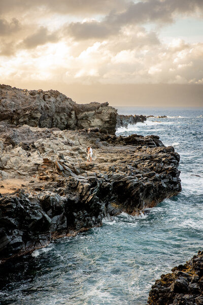Maui Wedding Photographer captures waves crashing against cliff before hawaii beach wedding