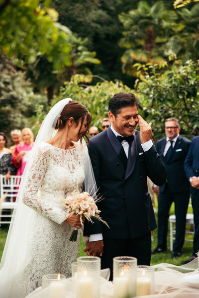 The groom is moved to tears during the heartfelt wedding ceremony, expressing the depth of his emotions in this touching and sincere moment