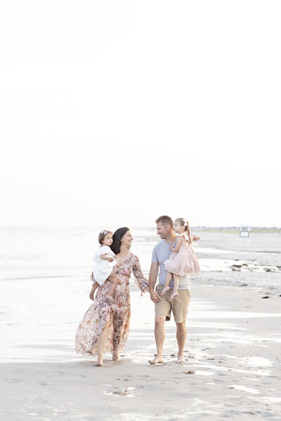 Family walking down the beach by philadelphia newborn photographer