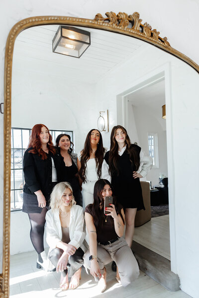 hair stylists looking in large mirror