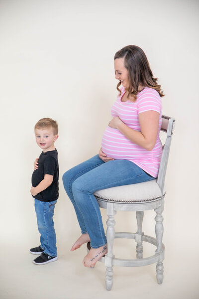 Photo with Mom holding belly and son mimicing her | Maternity Session