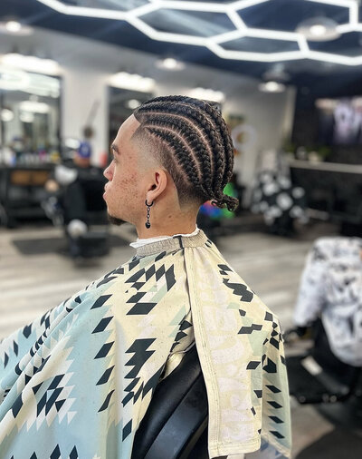 A finished cornrow straight back braid style at Onyx Barbershop in Wildomar, California.
