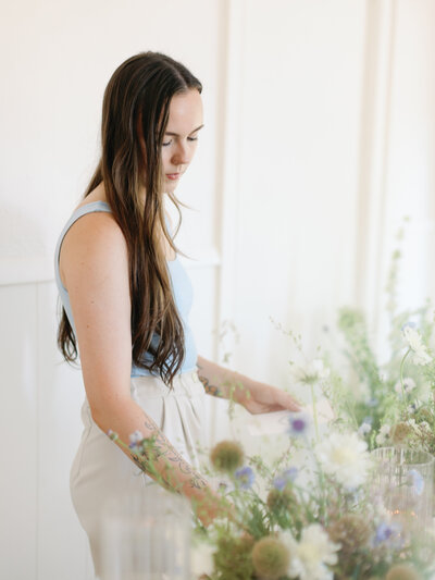 woman styles a reception table
