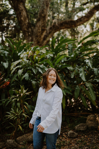 Brandi of the Intuitive Momma smiling outdoors. Learn more about her professional medical or athletic reiki services.