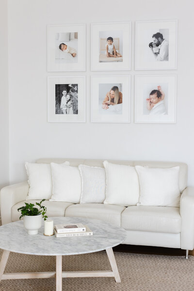 Wall gallery of photos  in white frames