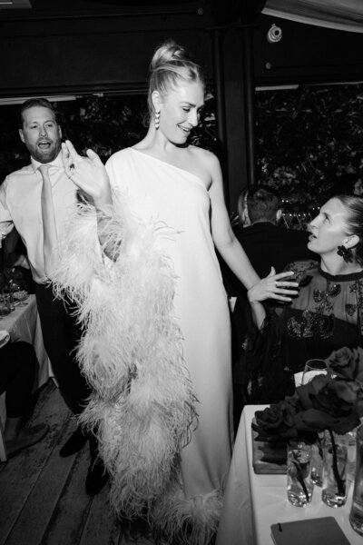 Reportage image of bride interacting with guests at the welcome dinner in Gatto Nero restaurant Lake Como.