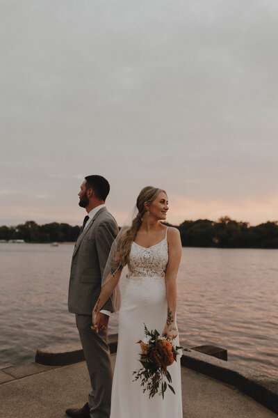 Couple holding hands looking away from the camera on the Mississippi in La Crosse, WI