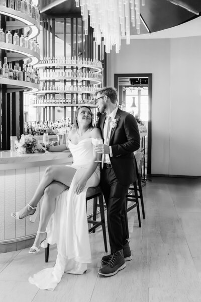 pink flowers in white vase with green leaves