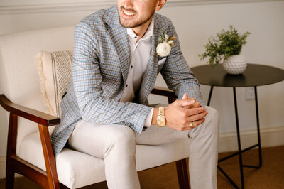 portrait of groom sitting in suit