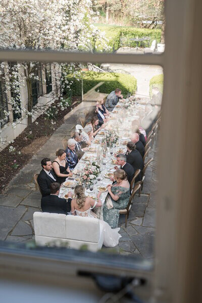 Wedding photography in Cincinnati Ohio of wedding party at a reception table in a garden