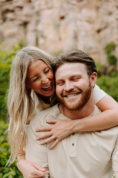 A person leaning over their partner's shoulder as they both laugh
