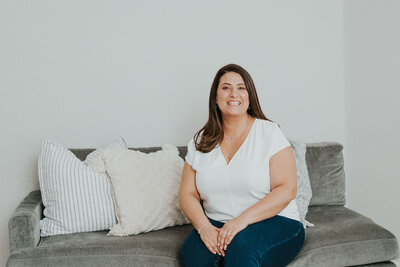Emily Calvo Sitting on her office couch. Contact a couples therapist or marriage counselor for support. An online therapist can provide it from the comfort of home!