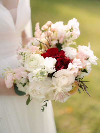November wedding at Graylyn Estate, designed and planned by Charming Carolina — close-up of the bride’s bouquet featuring seasonal blooms and textured fall foliage.