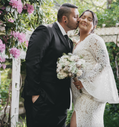 groom kissing bride on the cheek
