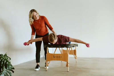 Dr Gwen places works with a patient targeting shoulder rehabilitation during an in home physical therapy session.