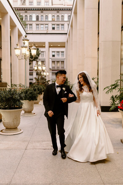 bride and groom walking with arms linked