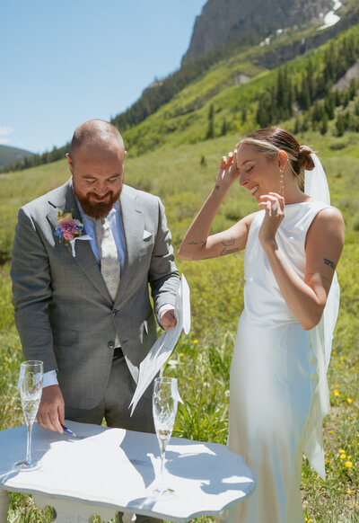A couple signs their marriage license in the mountains of colorado