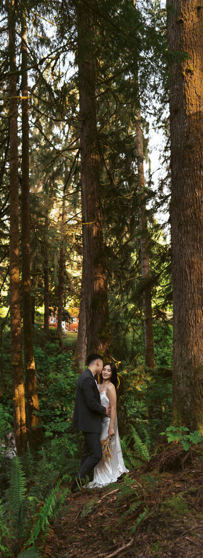 elopement bride sits on BMX bike as they  celebrate their Cannon Beach destination elopement