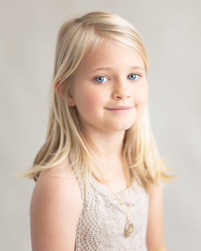 monochrome feel portrait of 8 year old girl with blue eyes