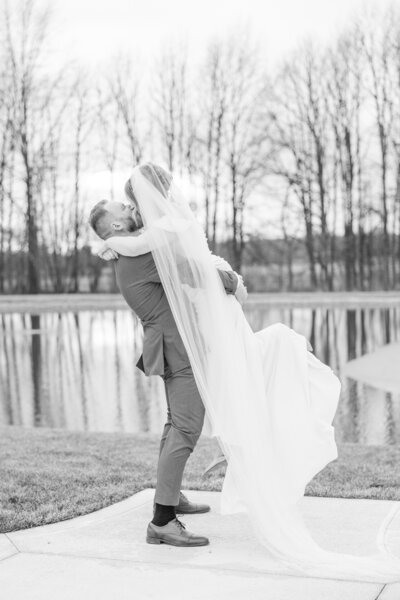 Cleveland Wedding Photographer natural light photographer groom lifting bride and kissing at Four Seasons Barn in Cardington Ohio