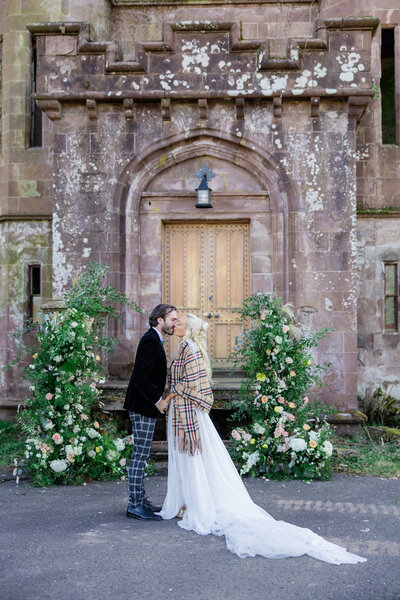 Glasgow bride and groom kiss in front of castle steps