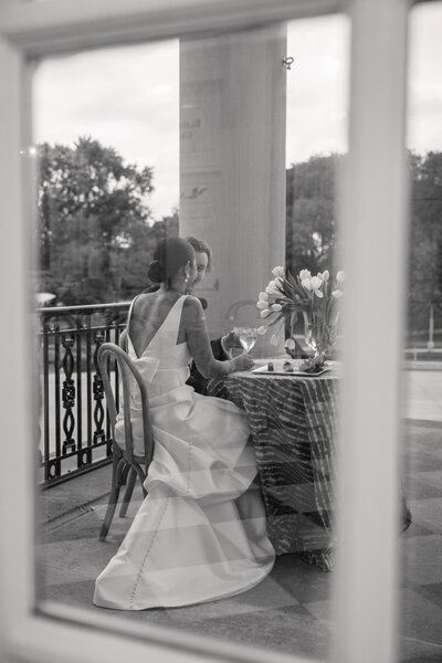 newlyweds sit at table for two