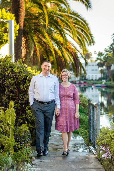 Couple walking and smiling at Venice Canals