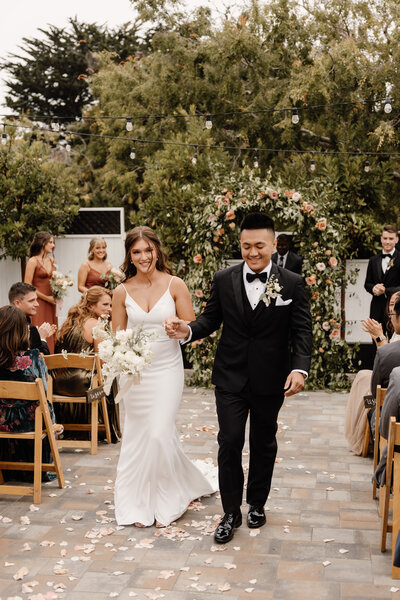 bride and groom walking down aisle in monterey