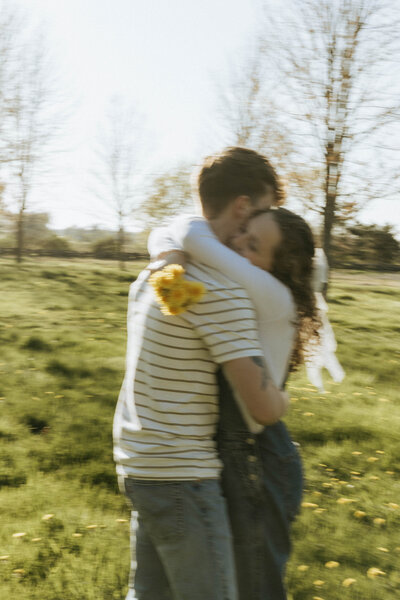 Whimsical engagement photos in a green field in West Michigan.
