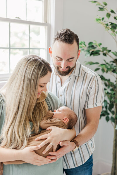 parents holding their newborn baby